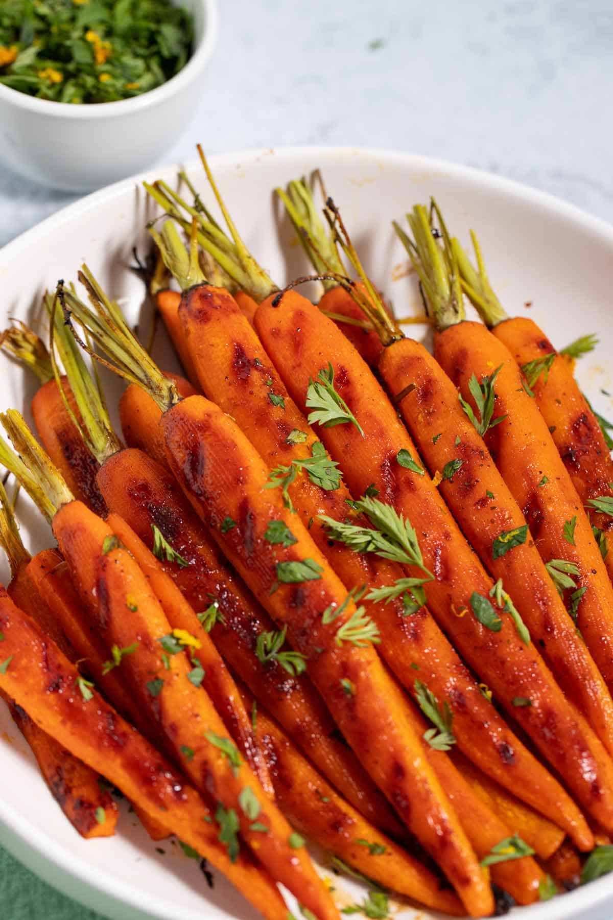 Plate of roasted brown sugar carrots.