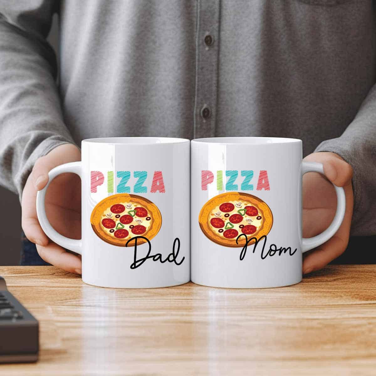 Two pizza mugs with one featuring pizza dad and the other featuring pizza mom.