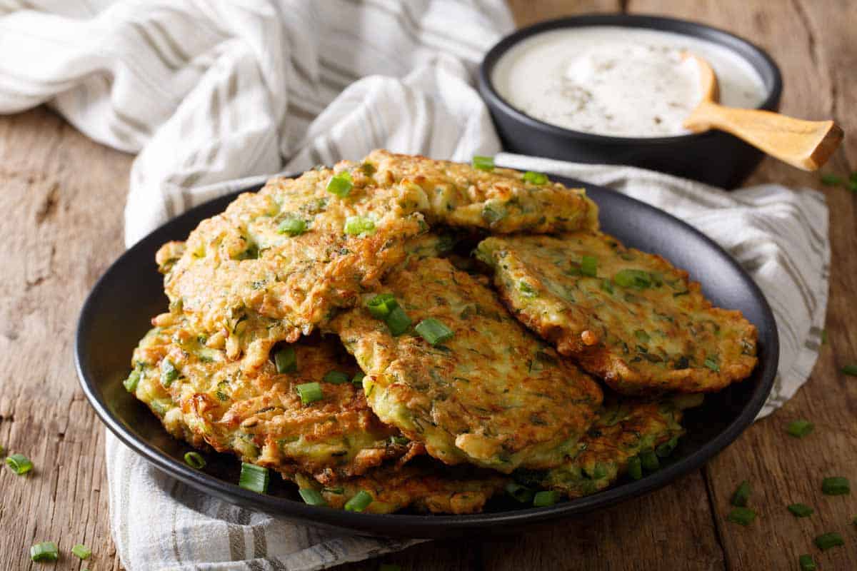 Plate of potato fritters with green onions.