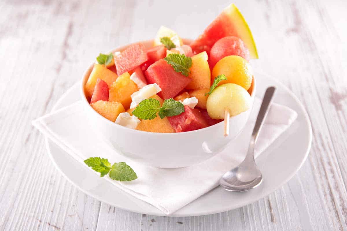 Bowl of fruit salad with melons.