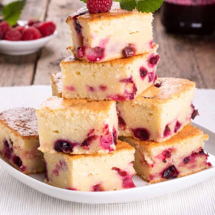 Stack of raspberry cheesecake squares.