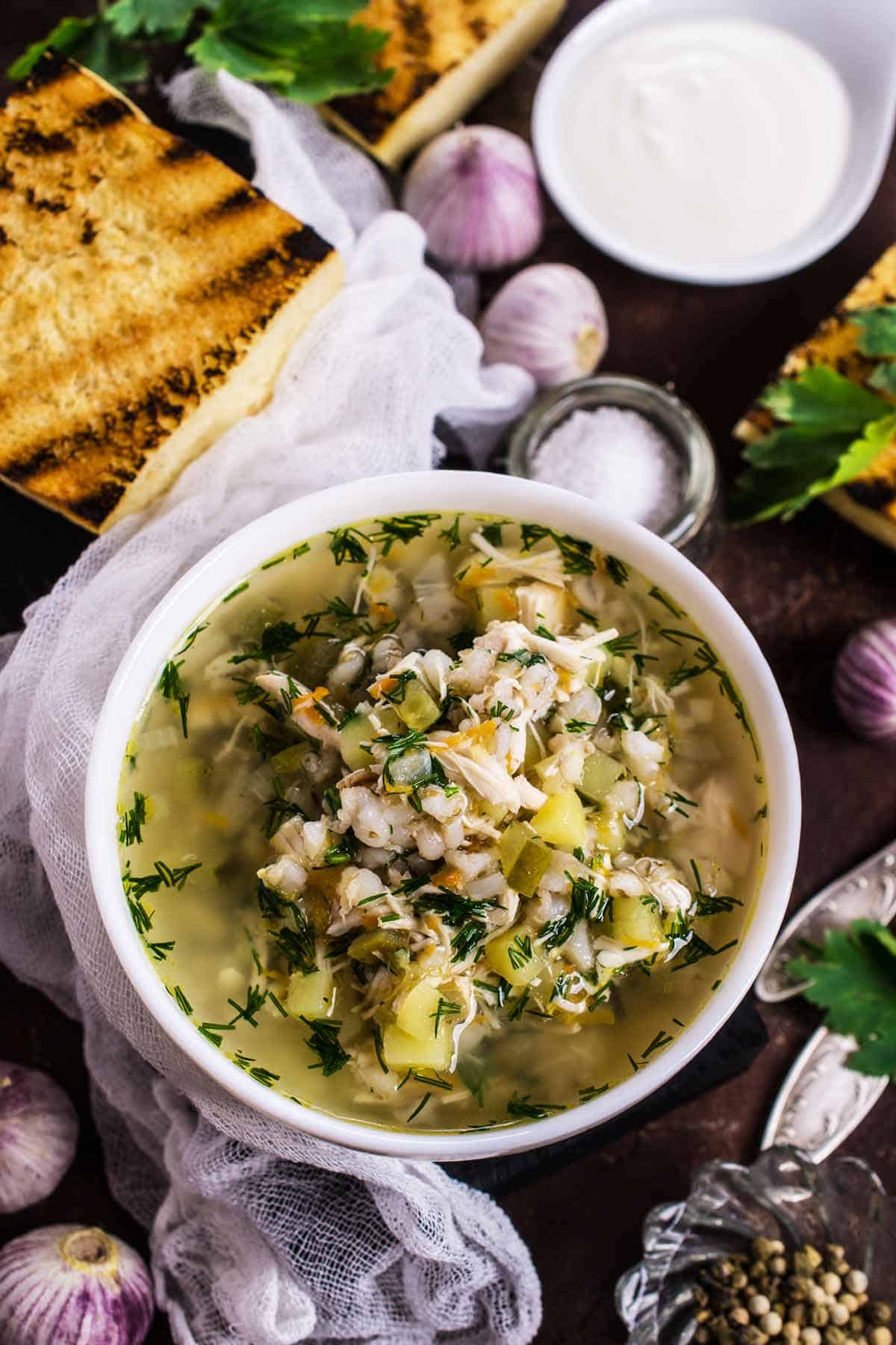 Bowl of turkey soup with side of bread.