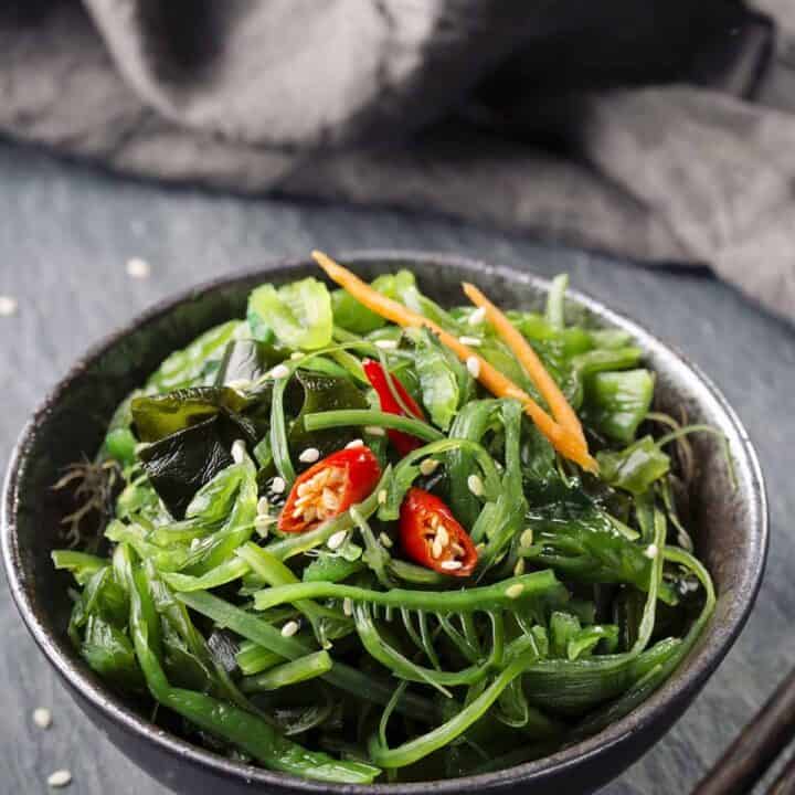 Bowl of Japanese seaweed salad with a napkin in the background.