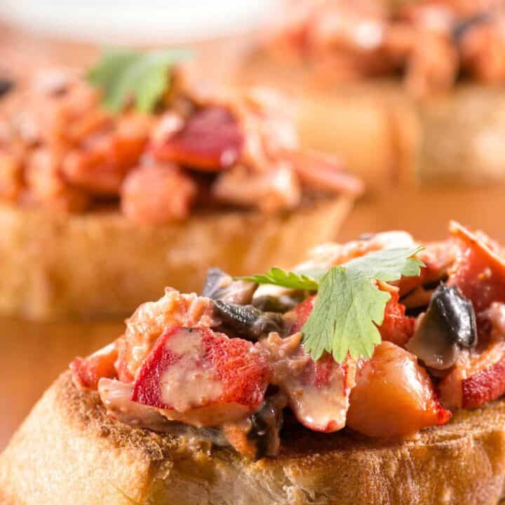 Lobster crostini on a board.