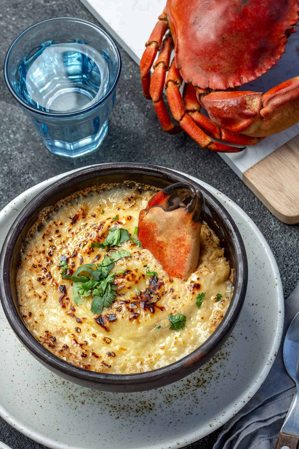 Crab soup with whole crab in the background.