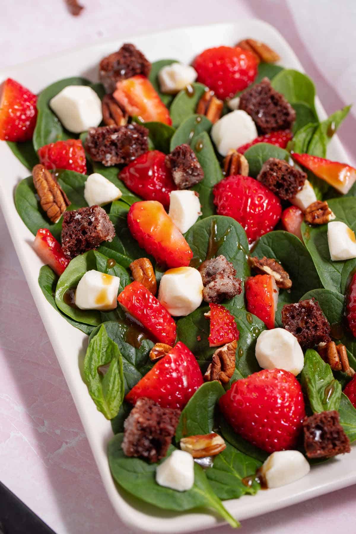 Spinach strawberry salad with chocolate cake croutons.