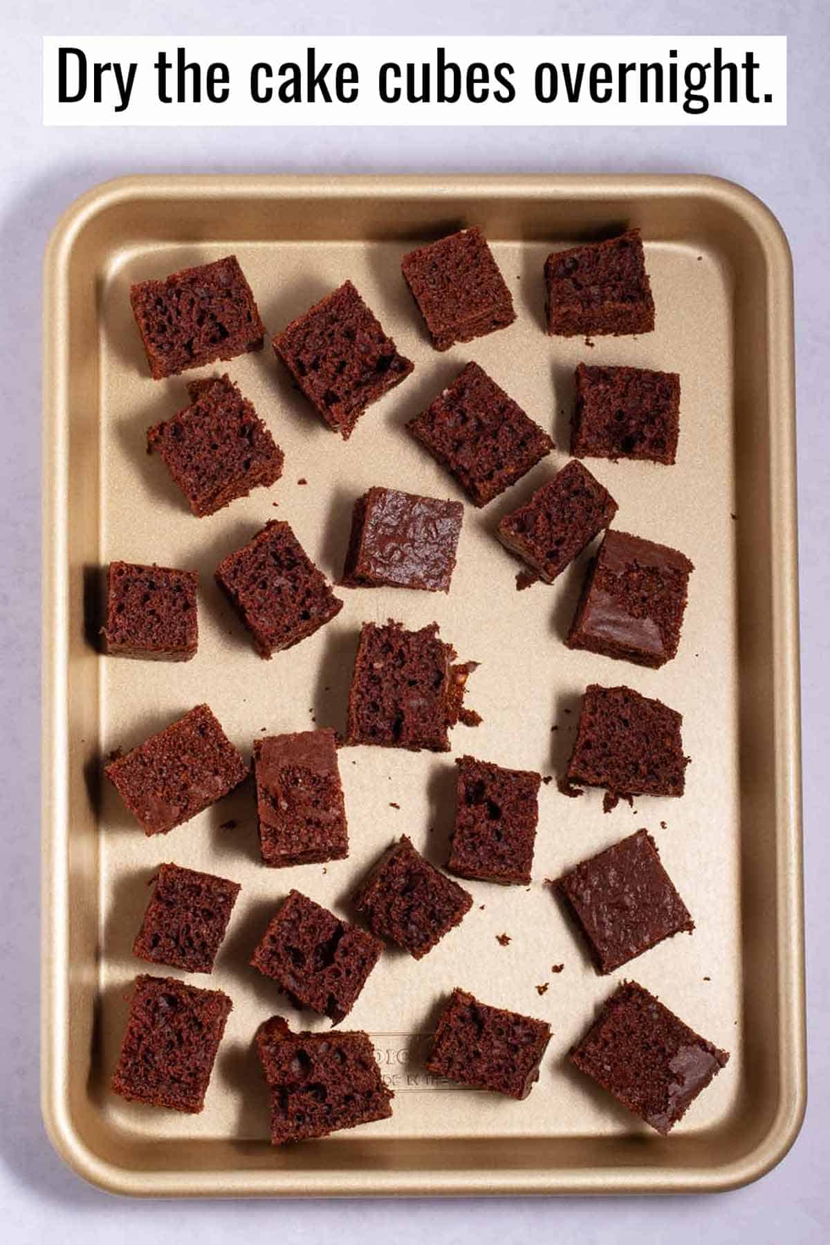 Chocolate cake cubes drying on an baking sheet.