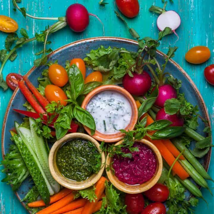 Crudité platter with veggies and 3 kinds of dip.