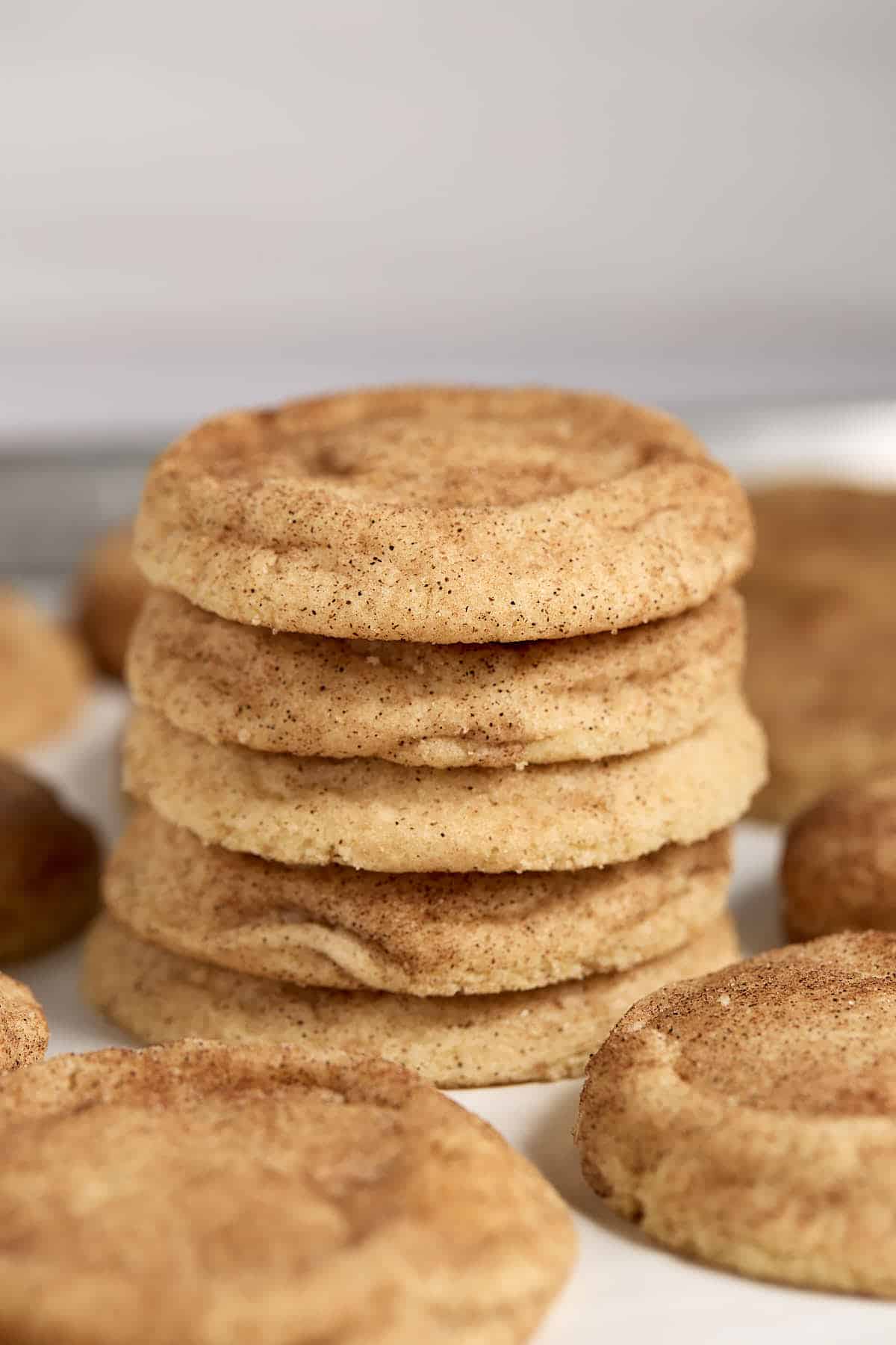 Stack of fluffy snickerdoodle cookies surround by other cookies.