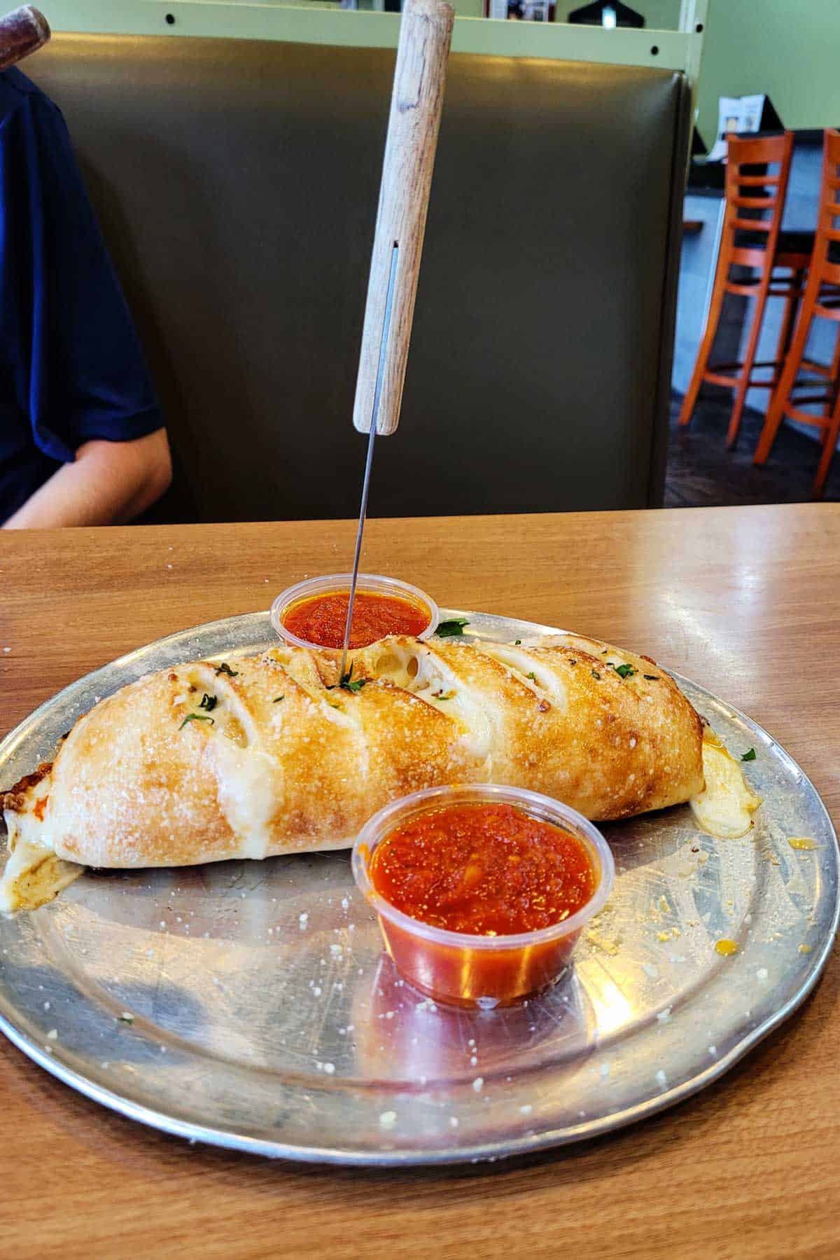 Calzone on a platter from Brooklyn V's pizza.