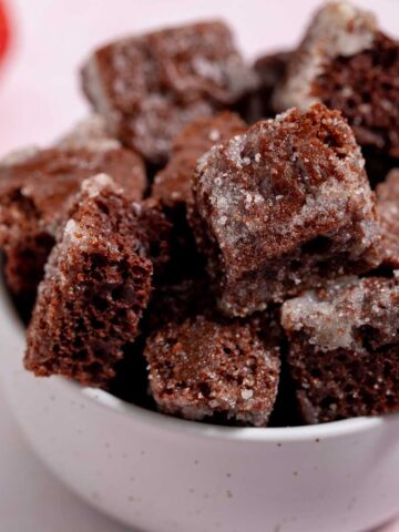 Bowl of chocolate cake croutons glazed with sugar.