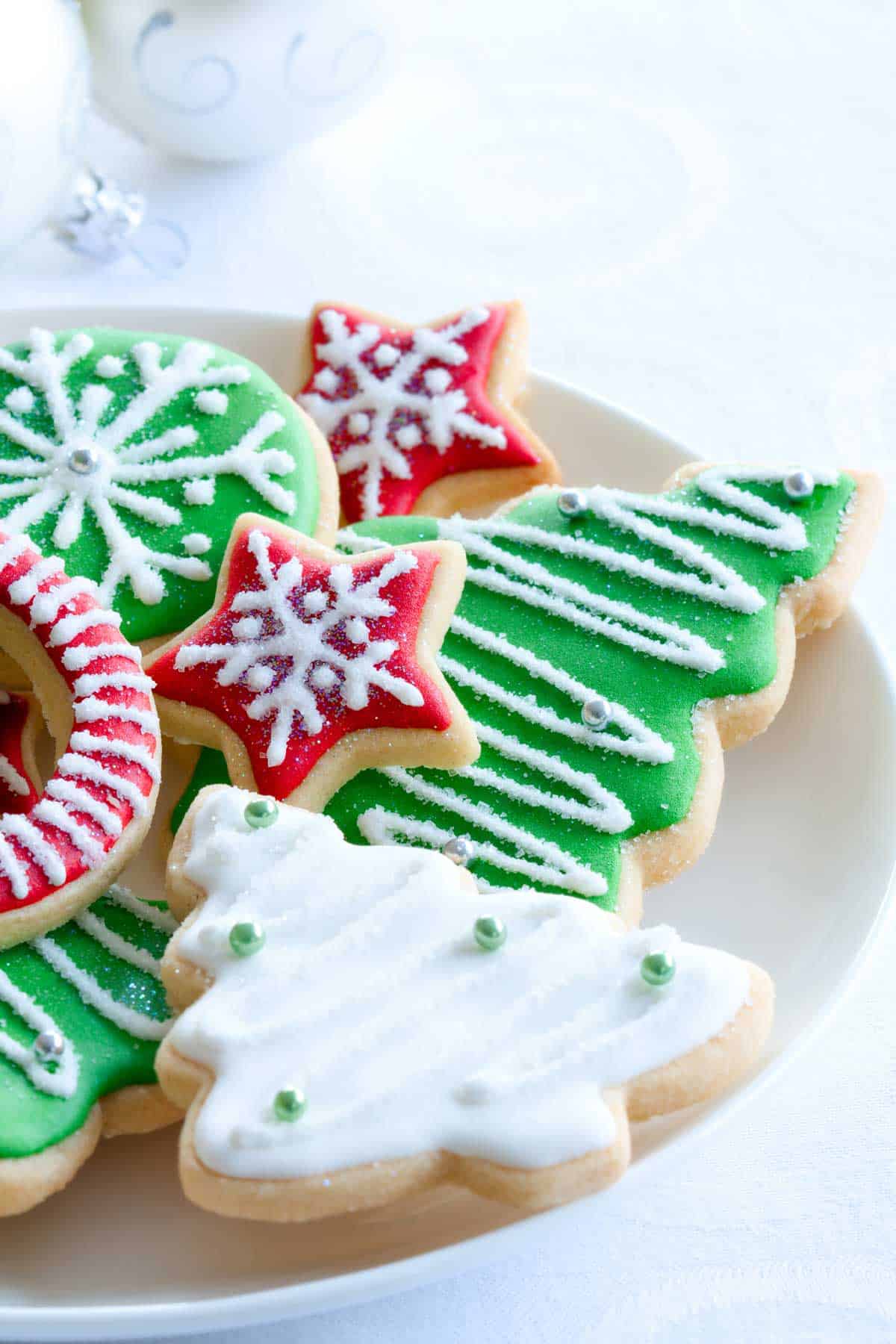 Plate of rolled sugar cookies decorated with royal icing.