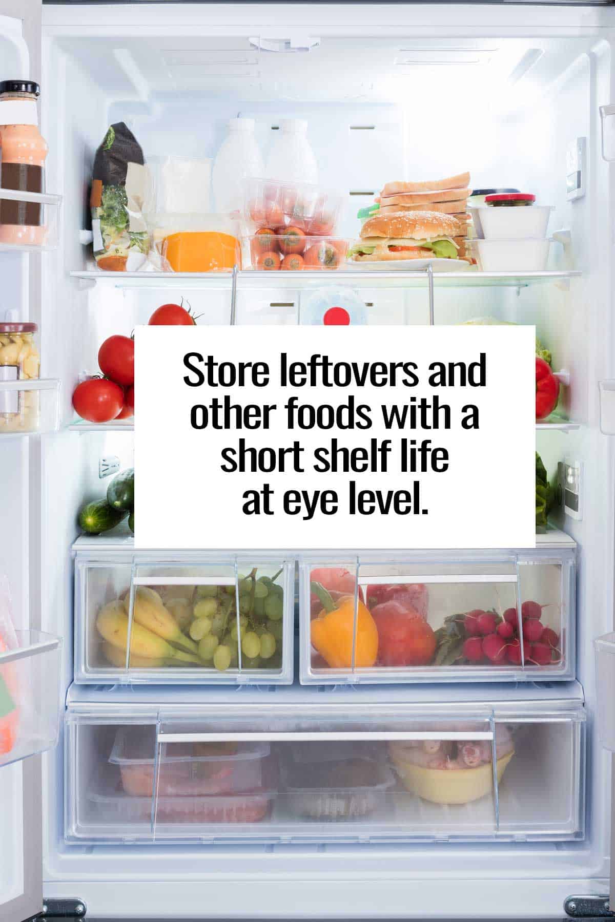 Open refrigerator with leftovers stored on the shelf at eye level.