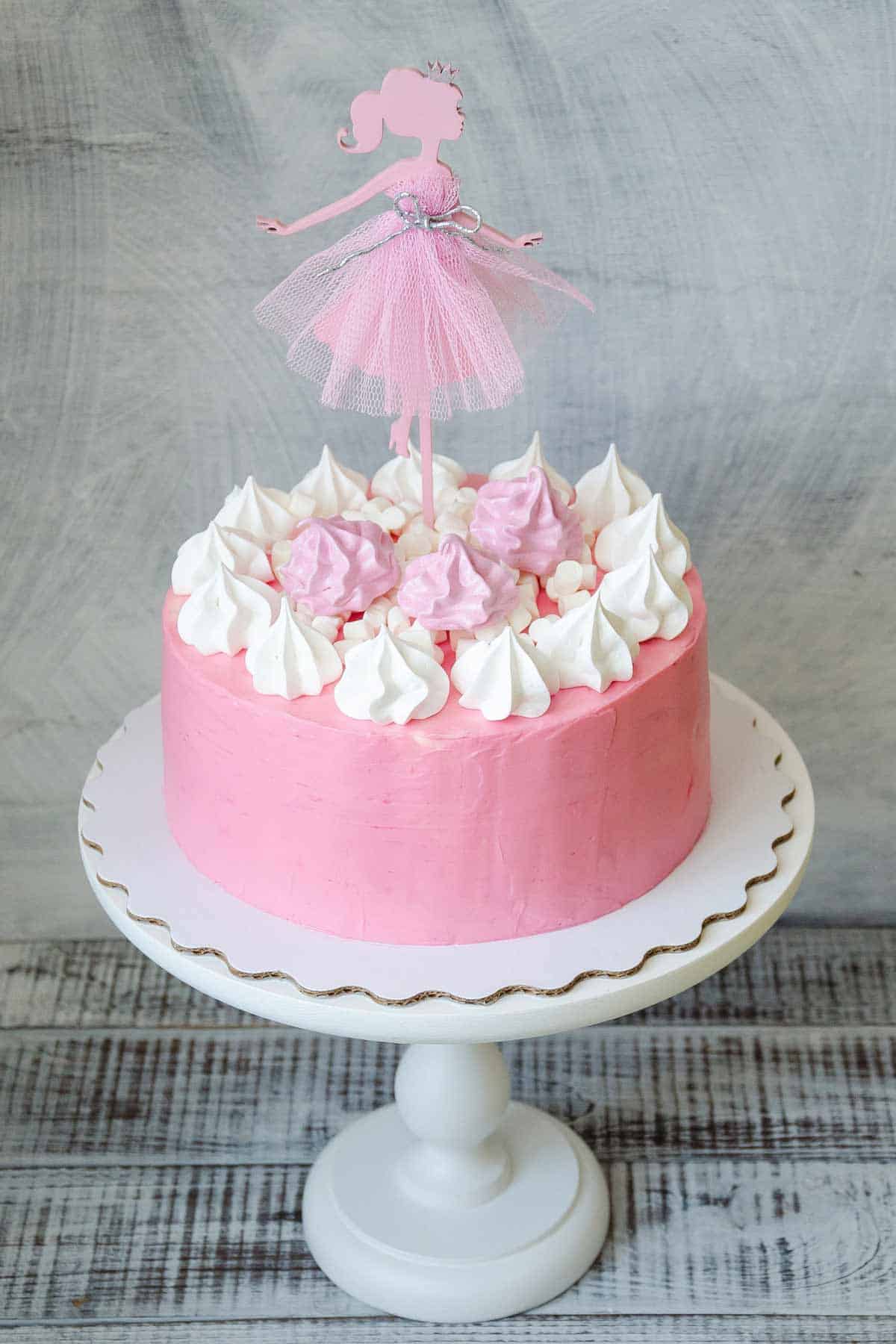 Simple pink princess cake with princess cut-out cake topper.