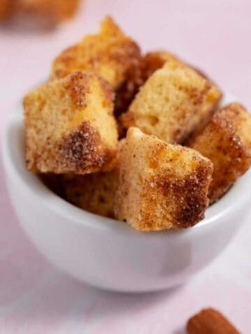 Bowl of cinnamon sugar pound cake croutons made with leftover pound cake cubes.