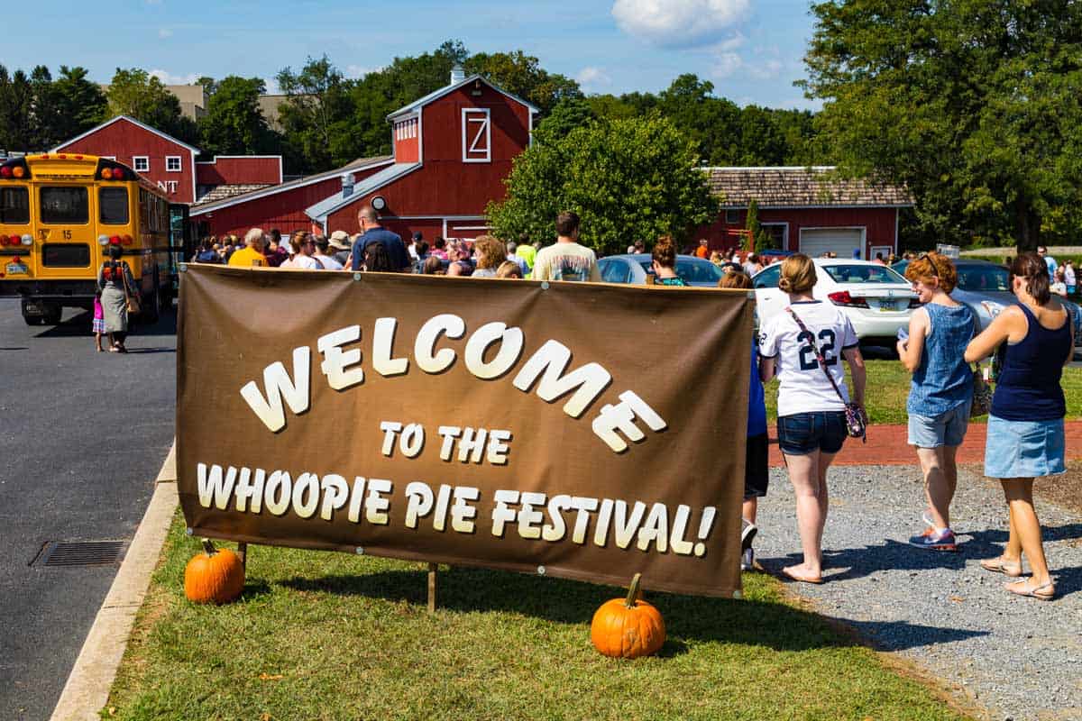 Entry sign to the Whoopie Pie Festival with guests entering.