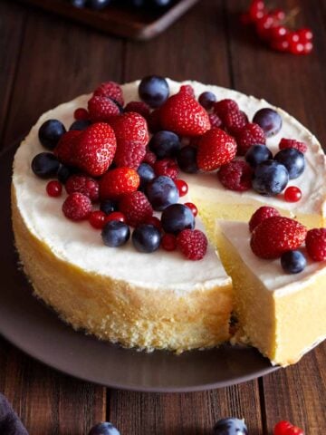 Cheesecake on a plate garnished with fresh berries.