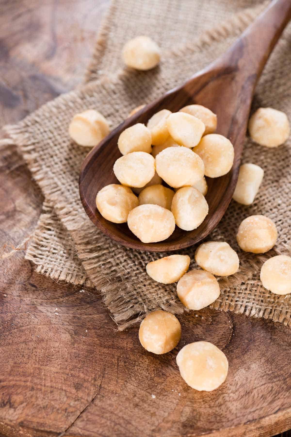 Wooden spoon with macadamia nuts.