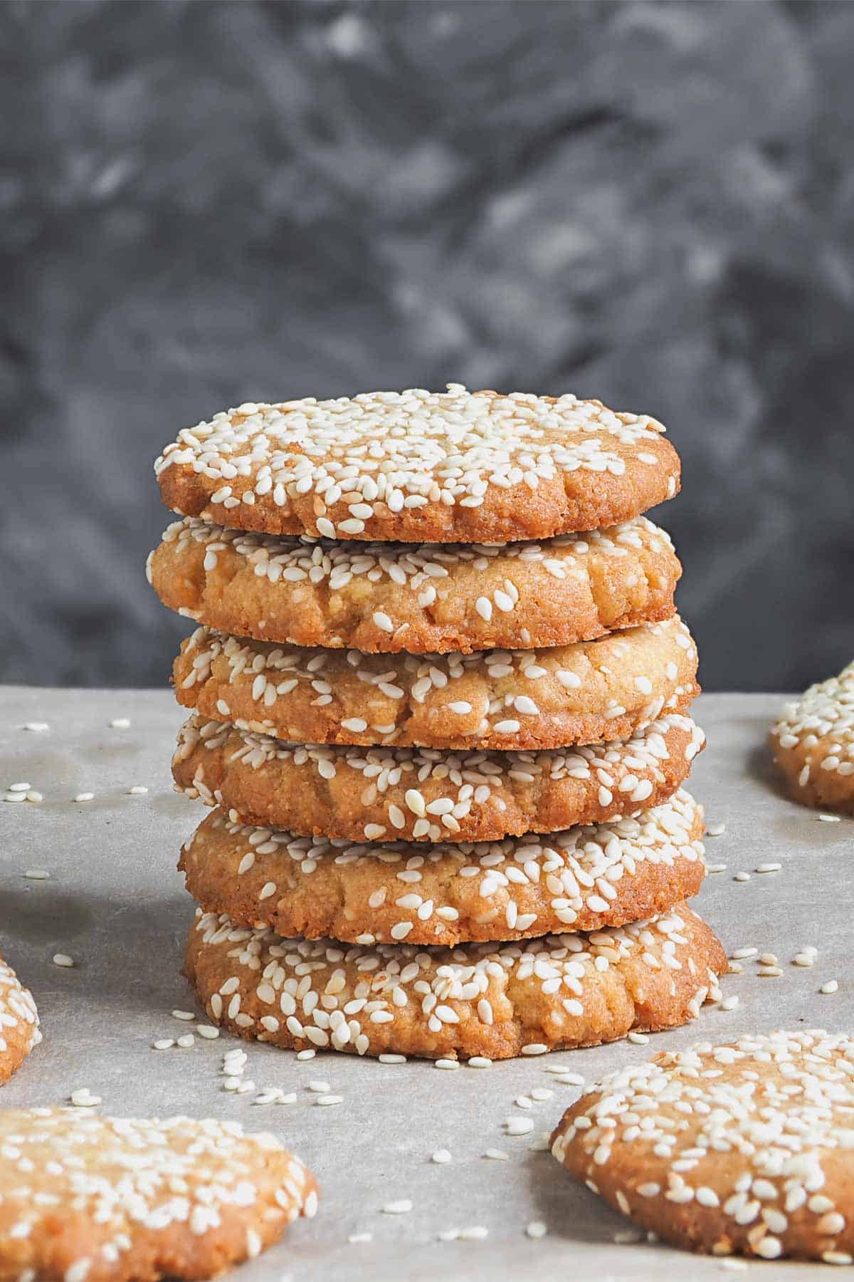 Stack of cookies sprinkled with sesame seeds.