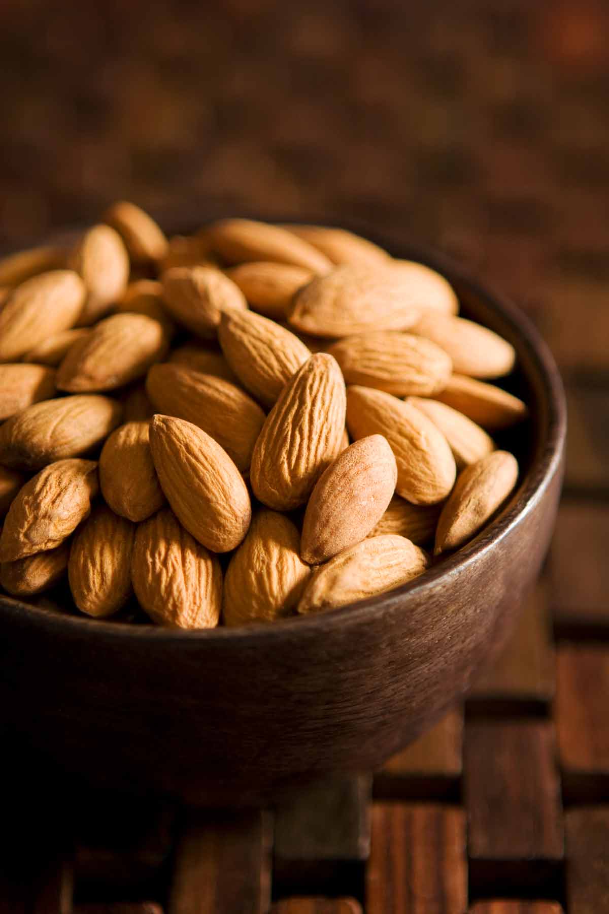 Bowl of whole, raw almonds.