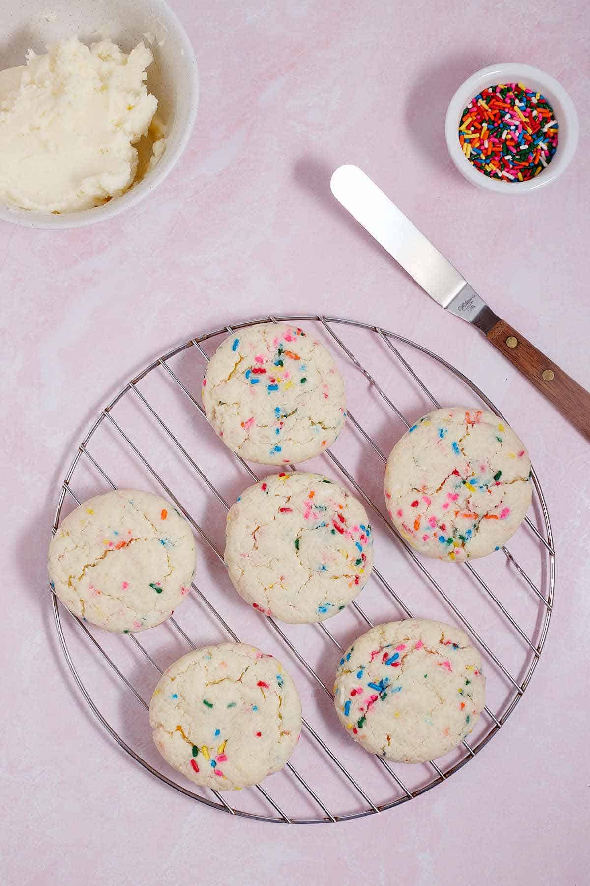 Funfetti cookies cooling on a wire rack.