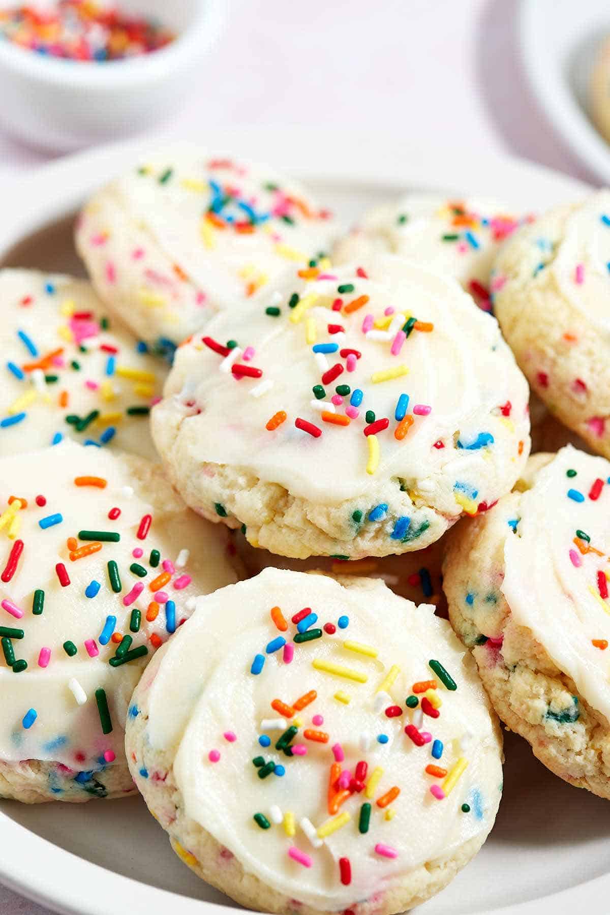 Plate full of Funfetti cake mix cookies frosted with sprinkles.