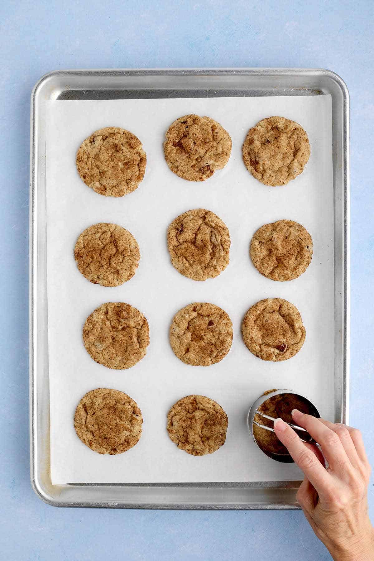 Shaping the baked cookies with a cookie ring.