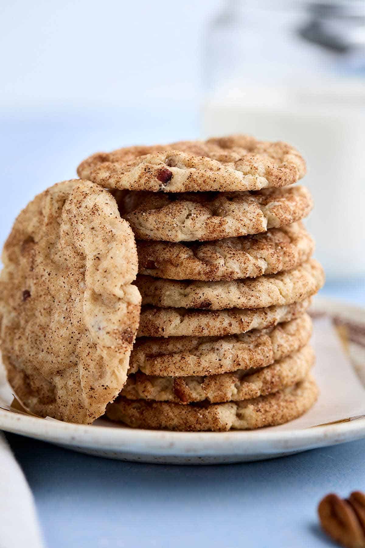 Stack of butter pecan cake mix cookies with one cookie leaning against the stack.