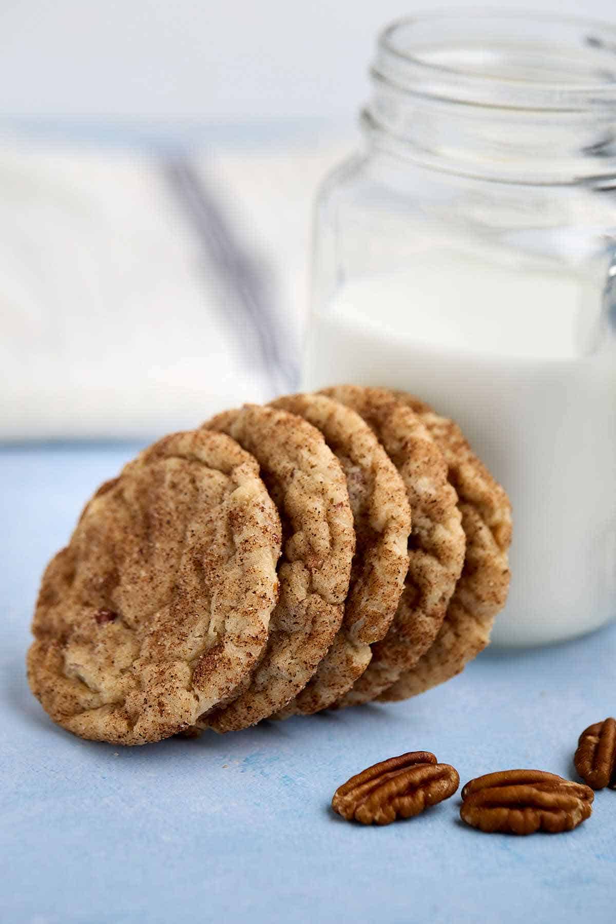 Butter pecan cake mix cookies leaning against a glass of milk.