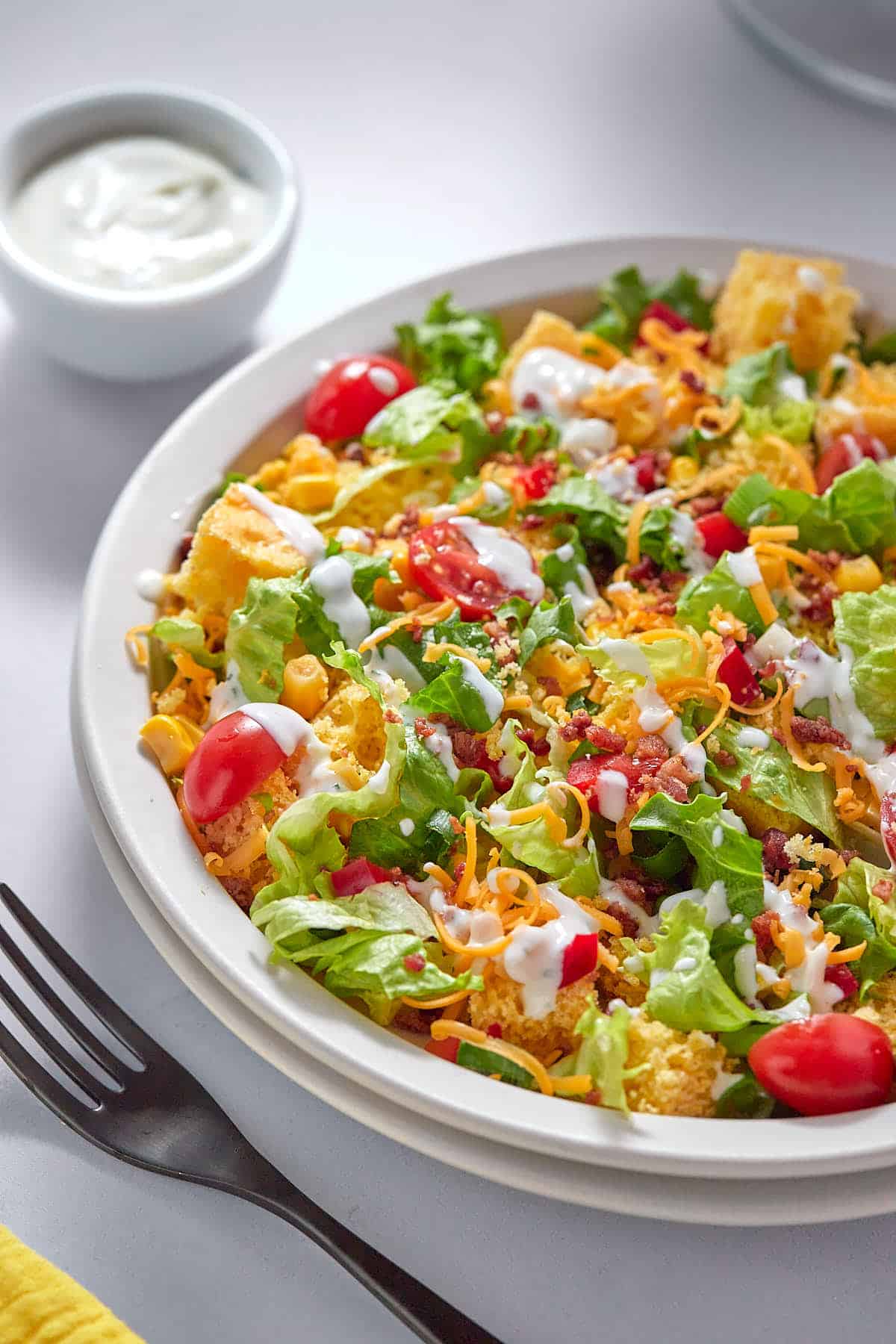 Cornbread salad on a plate with a fork.