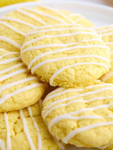 Pile of lemon cake mix cookies on a plate.