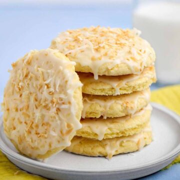 Stack of pineapple cake mix cookies with one leaning against the stack.