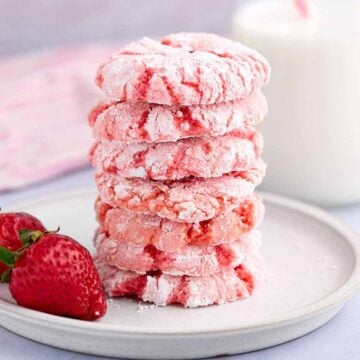 Closeup stack of strawberry crinkle cookies on a plate.