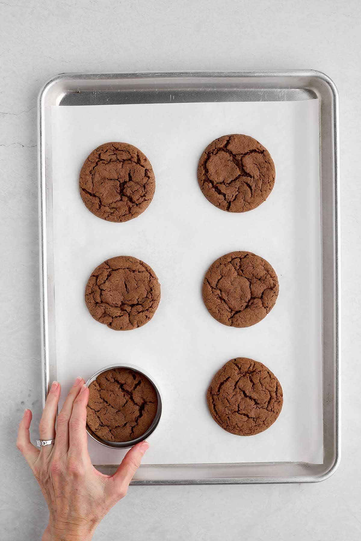 Circling the baked cookies with a cookie ring.