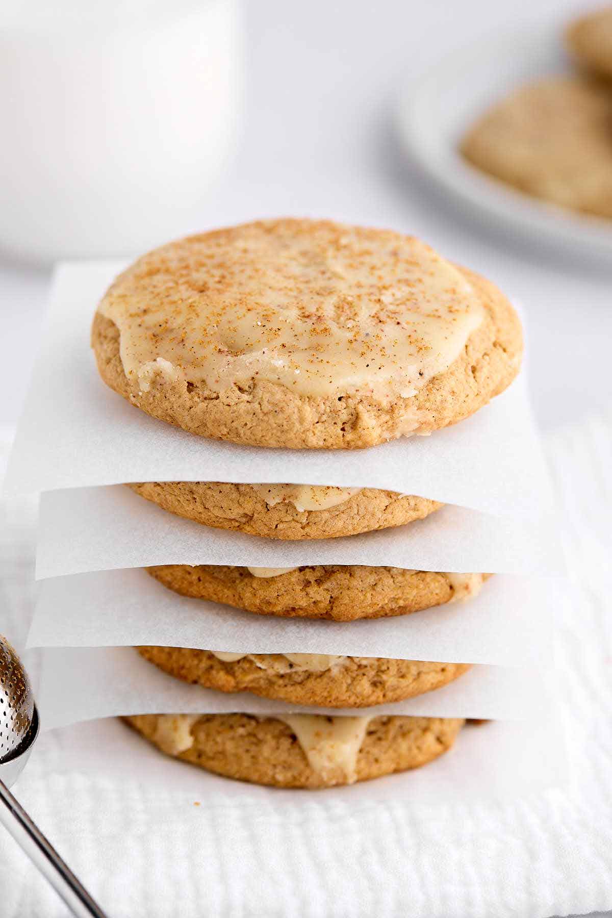 Stack of spice cake mix cookies with a parchment paper square in between each cookie.