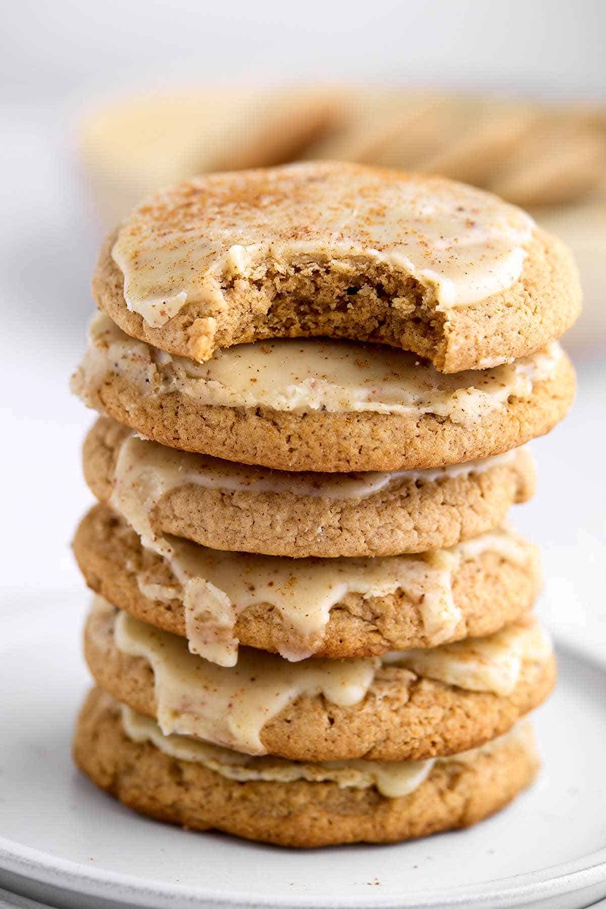 Stack of spice cake mix cookies with a bite taken out of the top cookie.