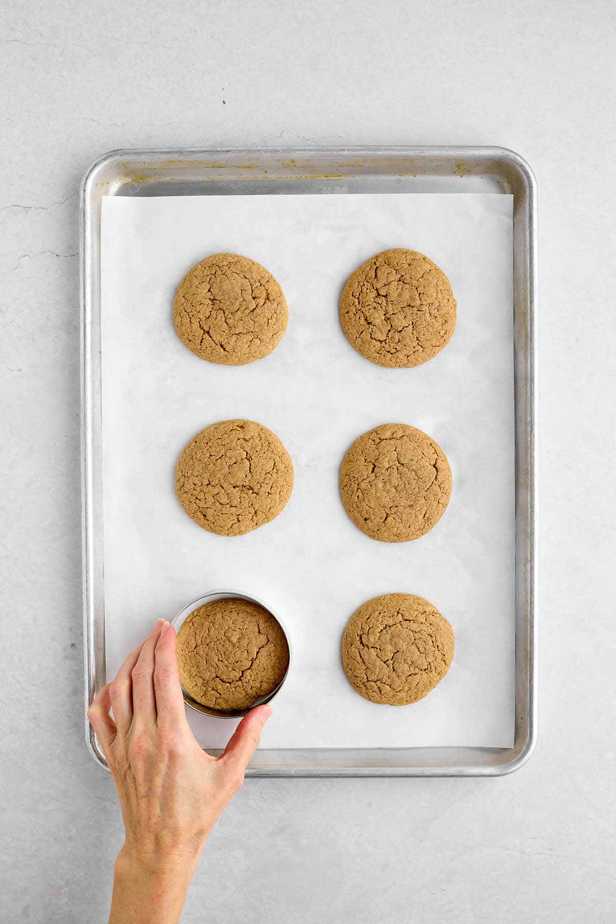 Cookie ring circling a warm spice cake mix cookie on a cookie sheet.