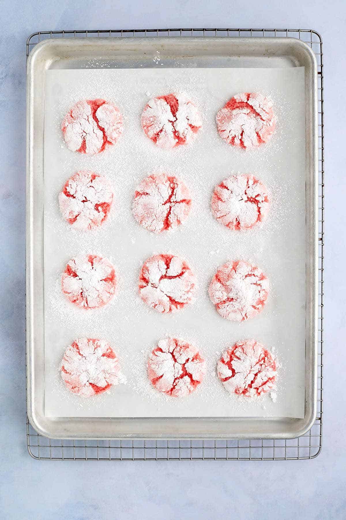 Cookie sheet of freshly baked strawberry crinkle cookies.