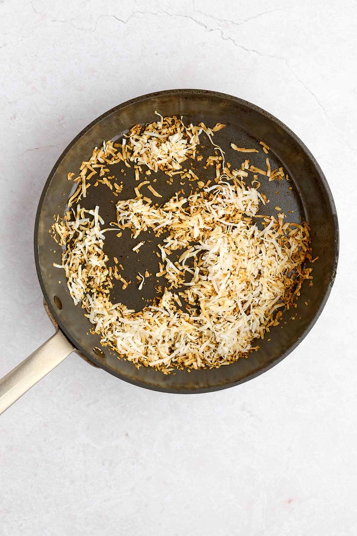 Skillet with toasted coconut.