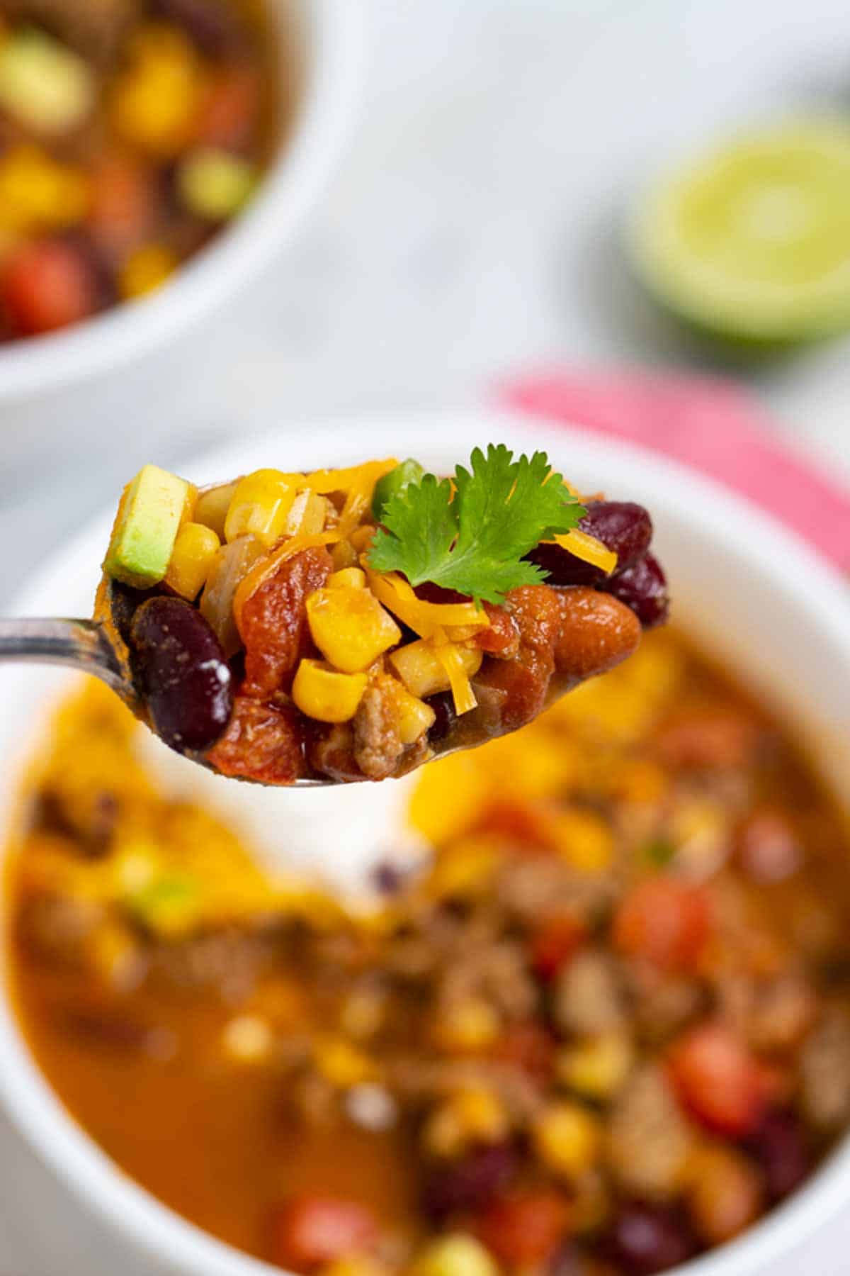 Spoon of taco soup with ground beef.