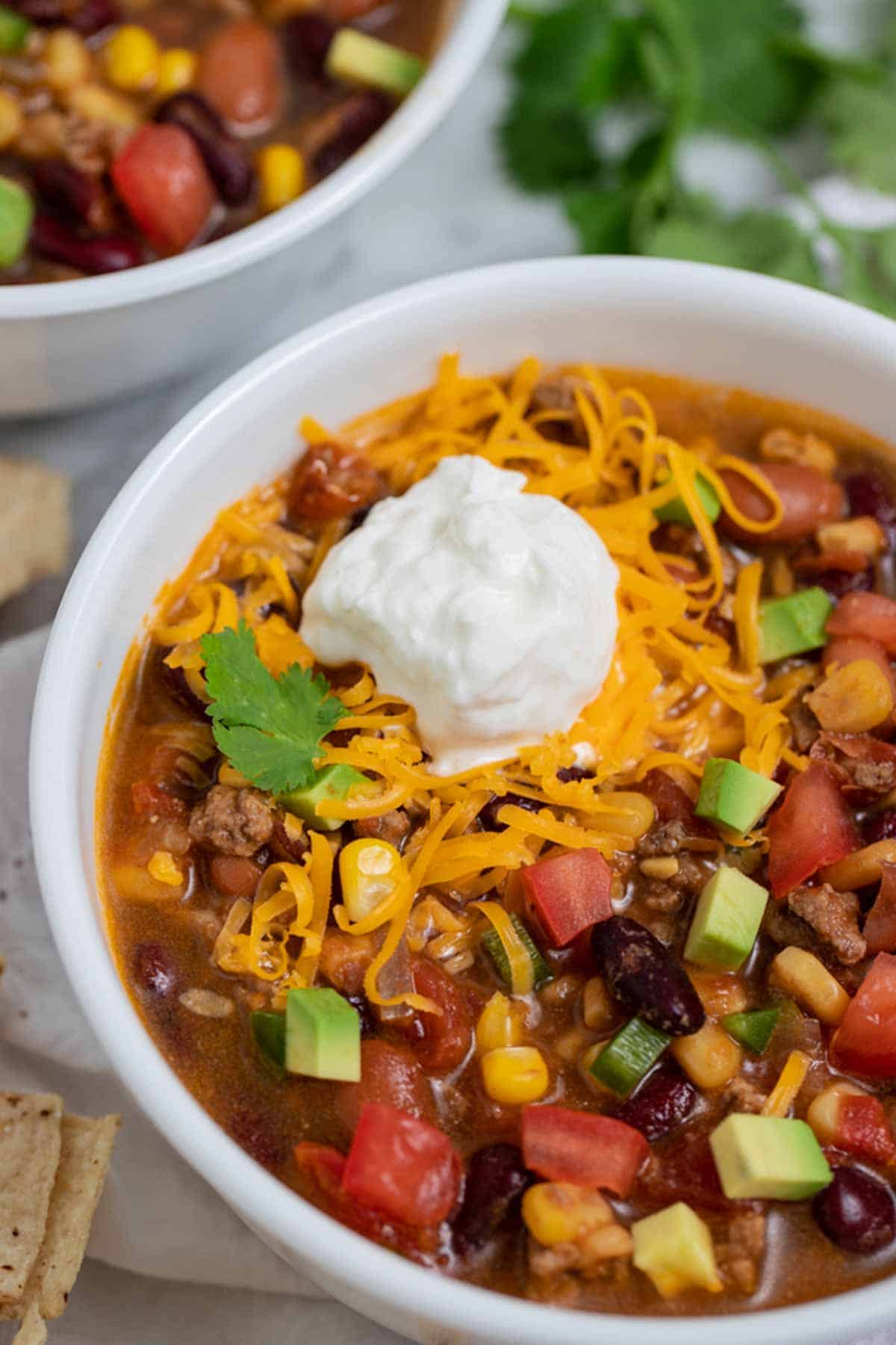 Ground beef taco soup with cheese and sour cream.