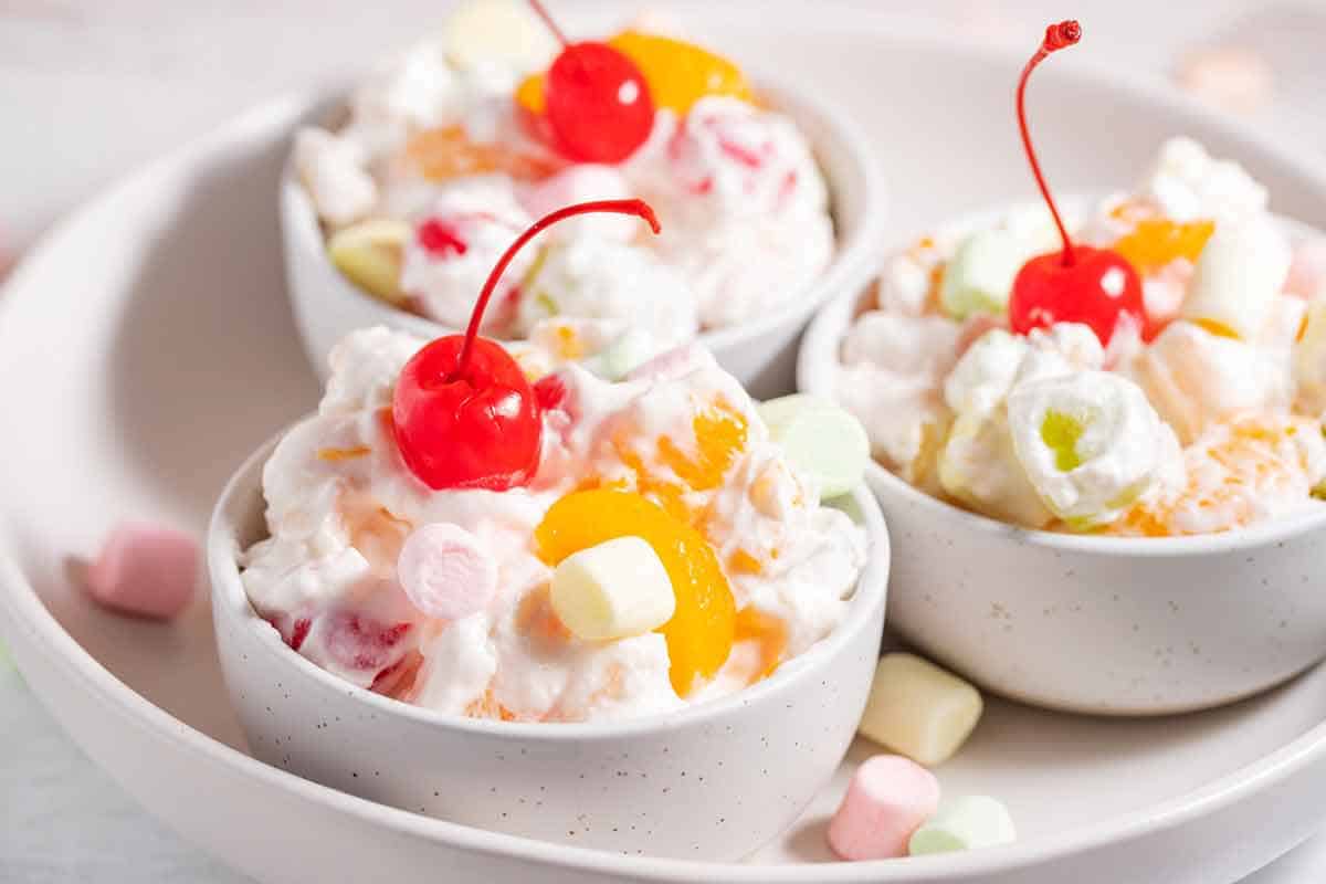 Small serving cups of ambrosia salad.