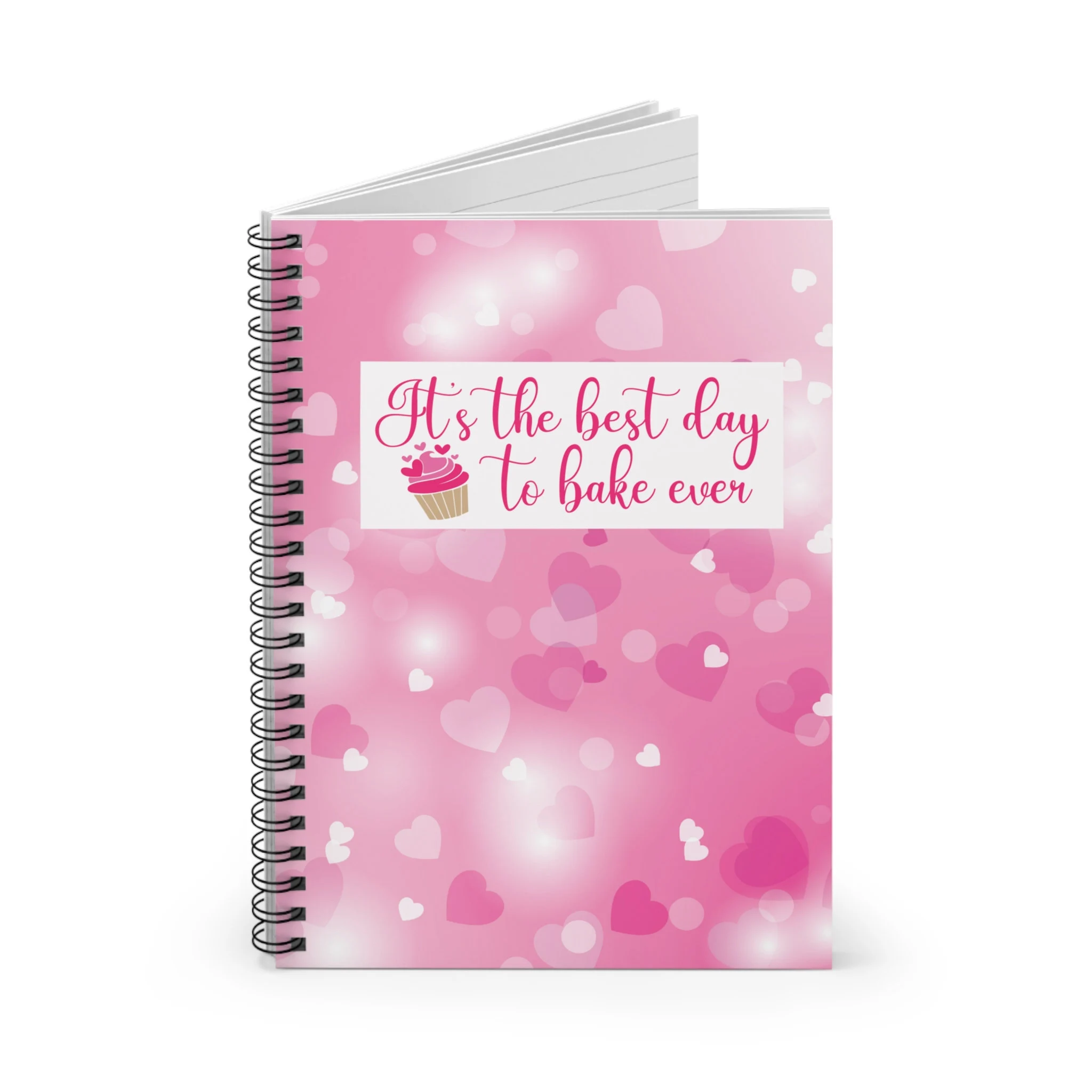 Pink spiral notebook with the text "it's the best day to bake ever".