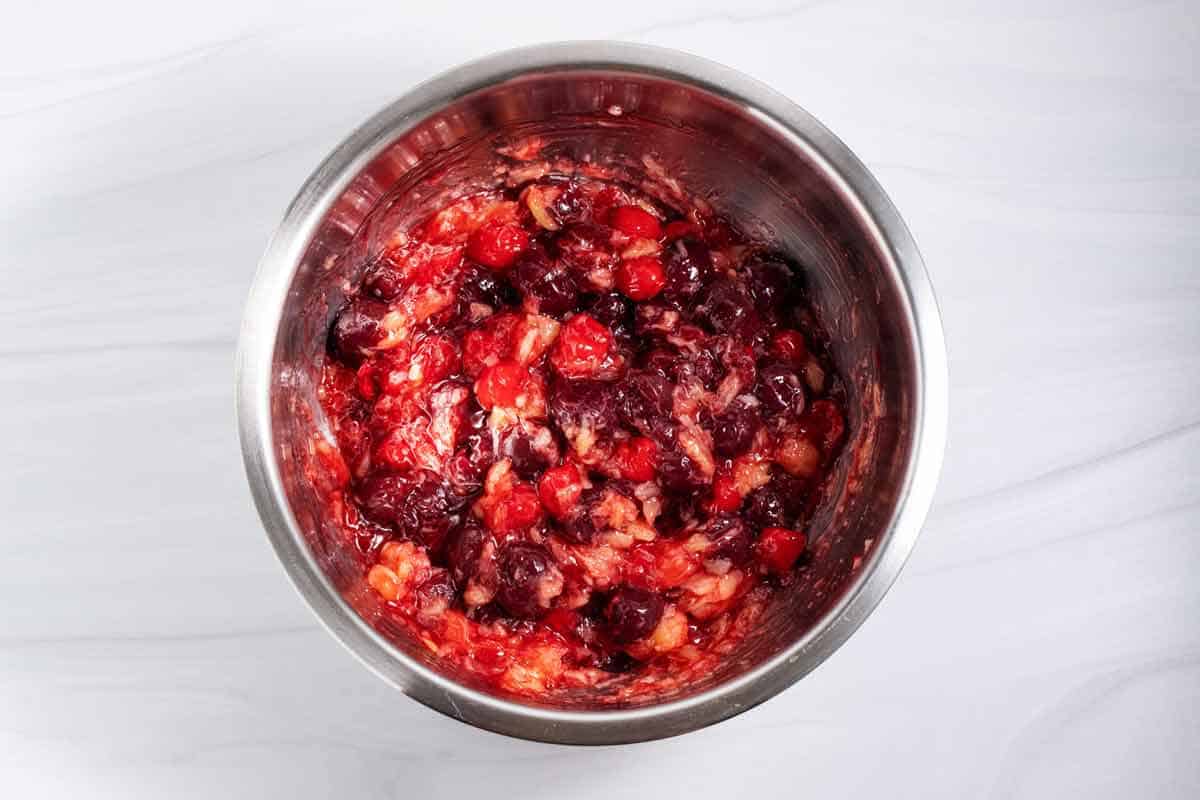 Fruit mixed together to make cherry fluff salad.
