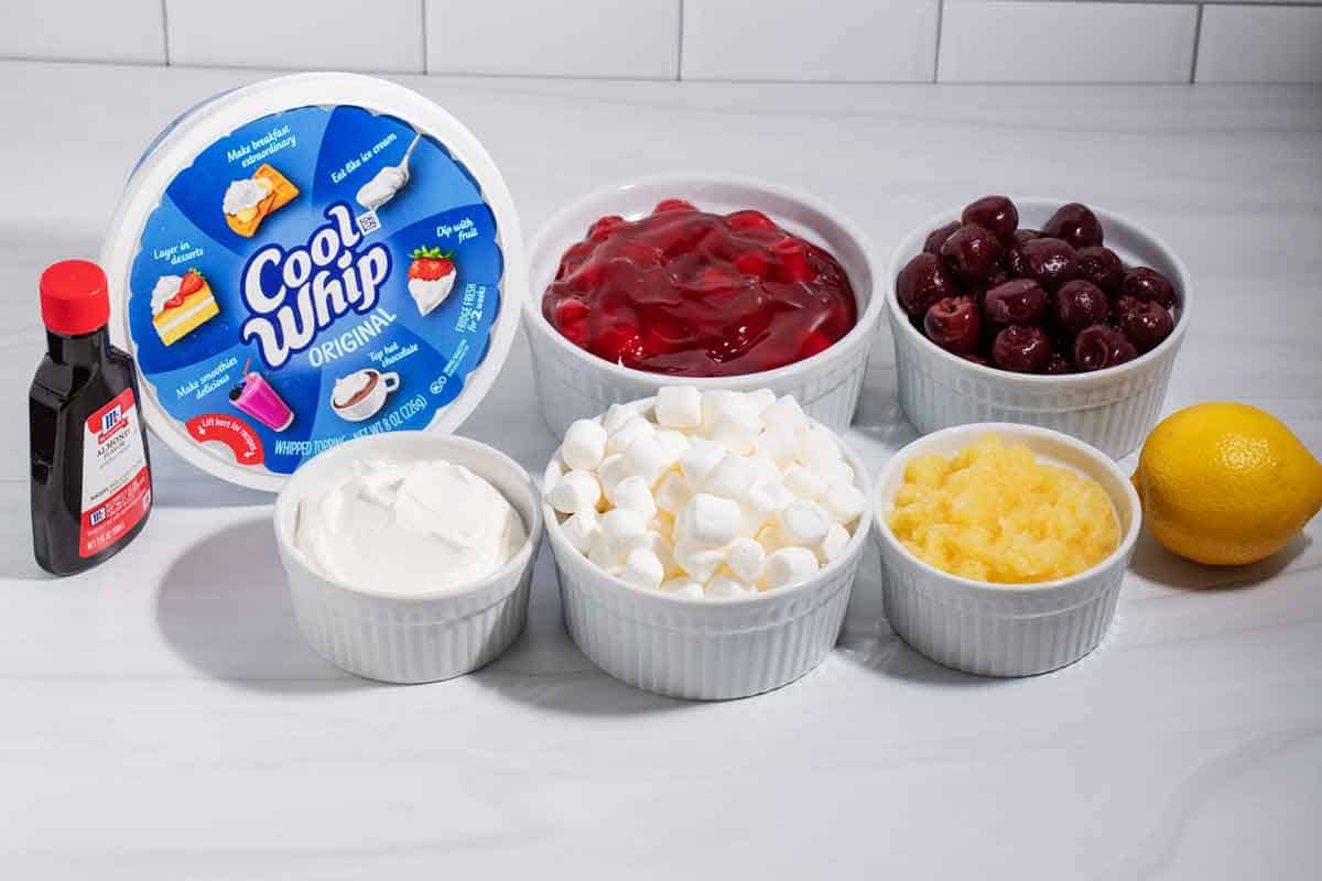 Ingredients for cherry fluff salad on the counter in bowls.