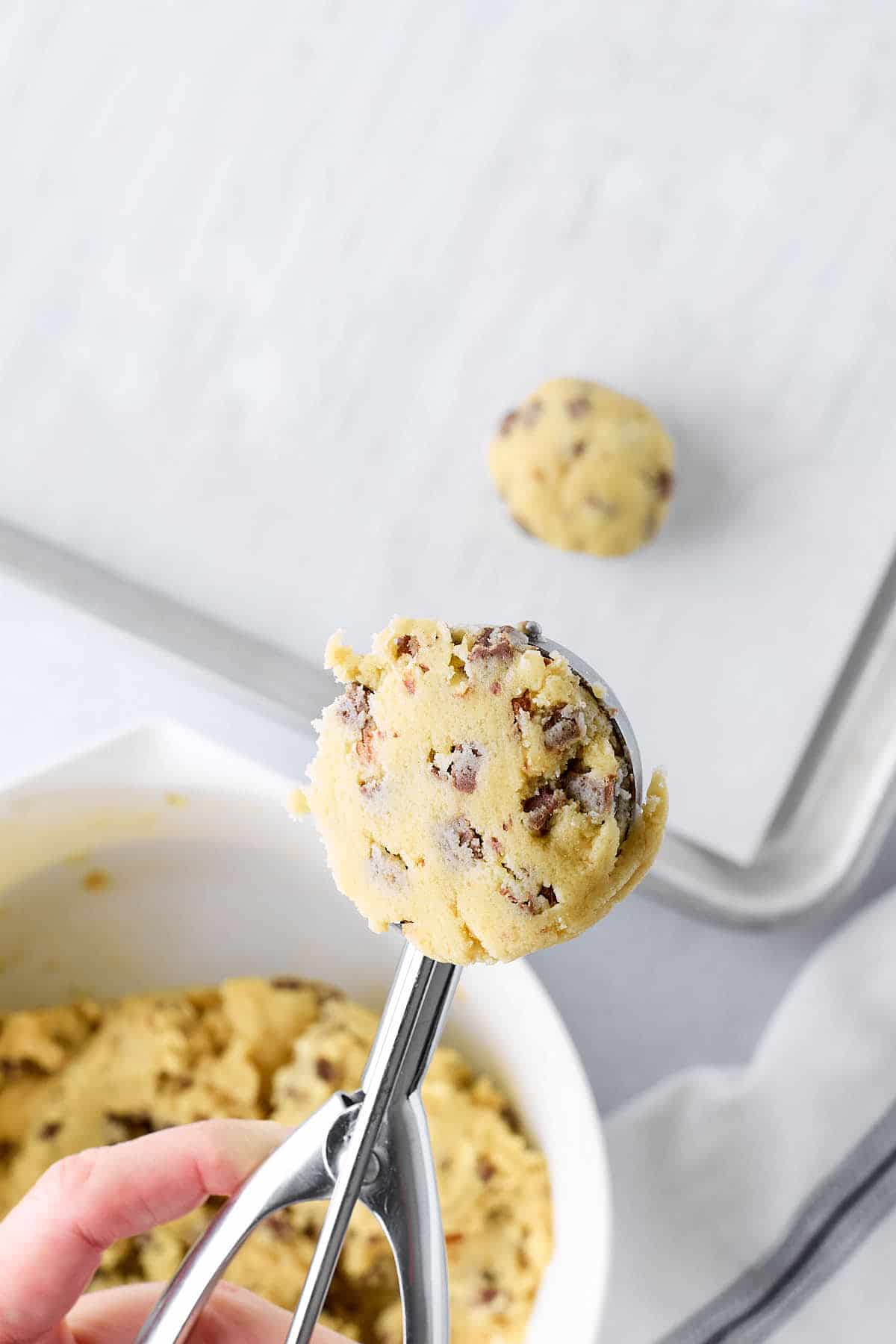 Cookie scoop of chocolate chip cookie dough.