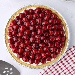 Whole no-bake cream cheese cherry pie made with canned filling and graham cracker crust.