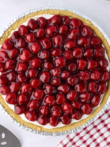 Whole no-bake cream cheese cherry pie made with canned filling and graham cracker crust.
